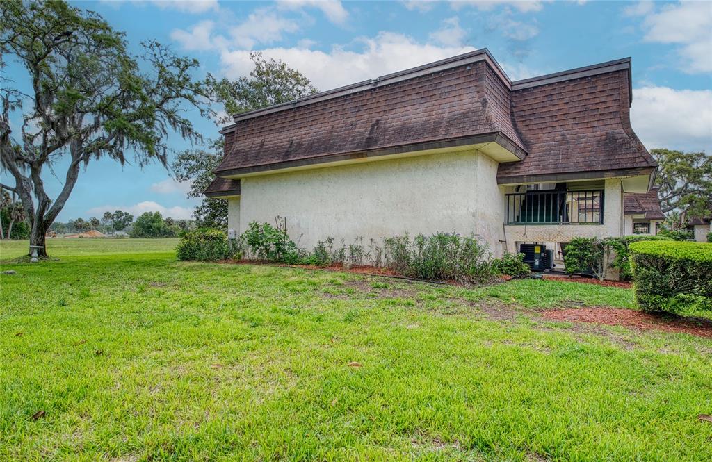 7040 Cognac Drive, Unit 3 New Port Richey, FL 34653 - Photo 4 of 31 a backyard of a house with lots of green space