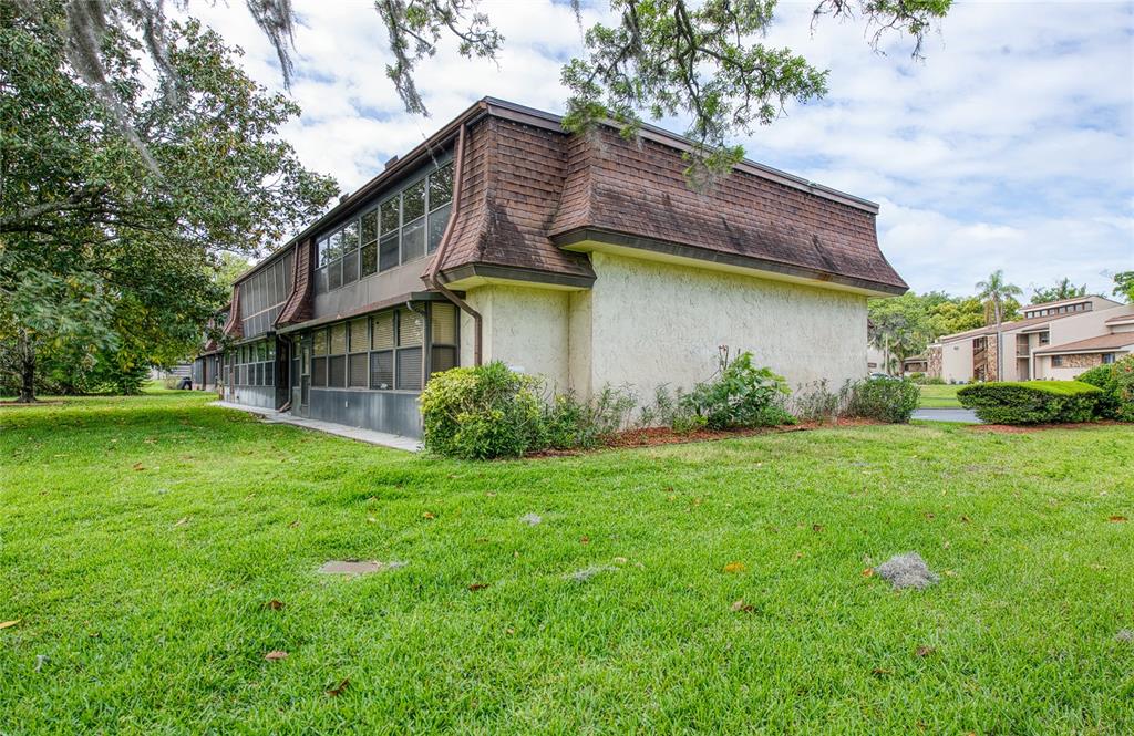 7040 Cognac Drive, Unit 3 New Port Richey, FL 34653 - Photo 5 of 31 a front view of a house with garden