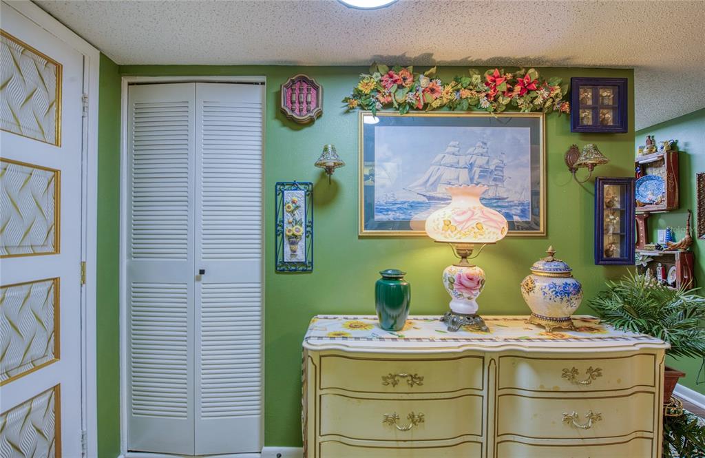 7040 Cognac Drive, Unit 3 New Port Richey, FL 34653 - Photo 7 of 31 a room with painting on the wall and a table