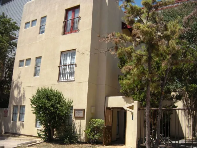 a view of a house with a tree
