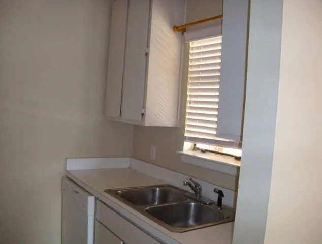 a kitchen that has a sink and a window