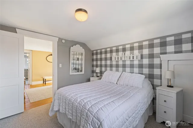 a bedroom with a bed and dresser with mirror