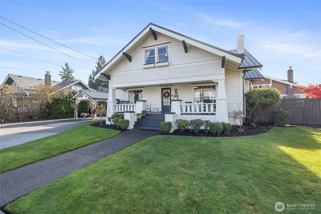 a front view of a house with a garden and plants