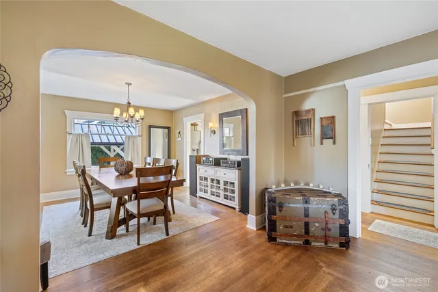 a dining room with furniture and wooden floor