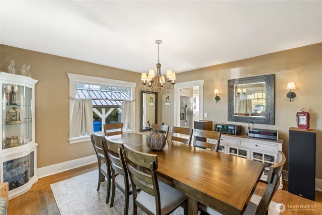 a dining room with furniture window and wooden floor