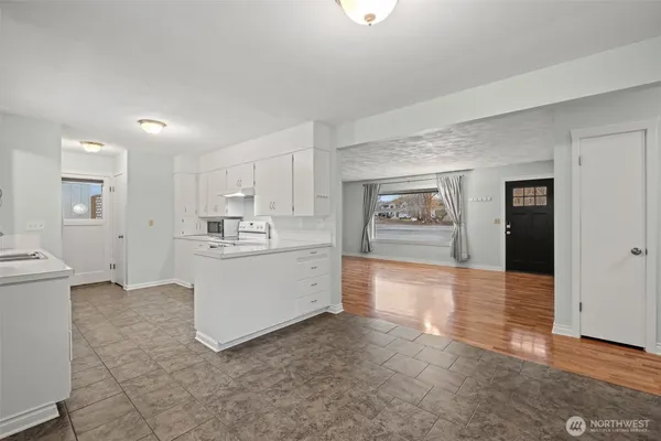 a view of a kitchen with a sink and a refrigerator