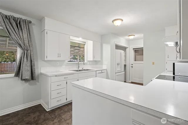 a kitchen with a sink a stove and refrigerator
