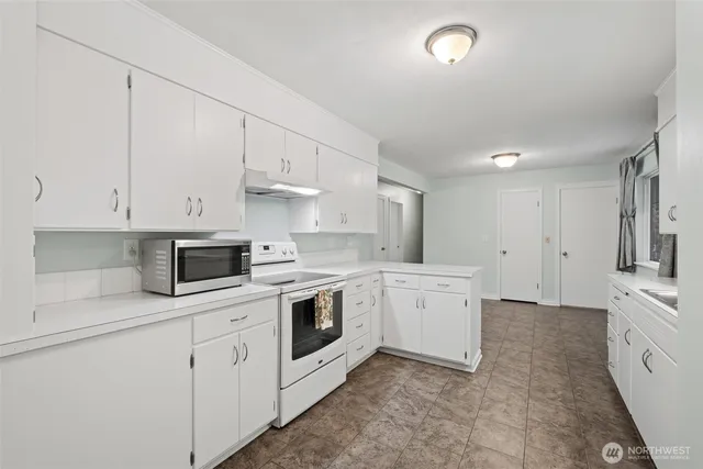 a kitchen with a sink and cabinets