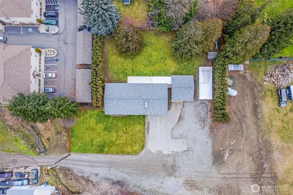 an aerial view of a house with a yard