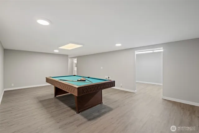 a view of a room with wooden floor and bathroom