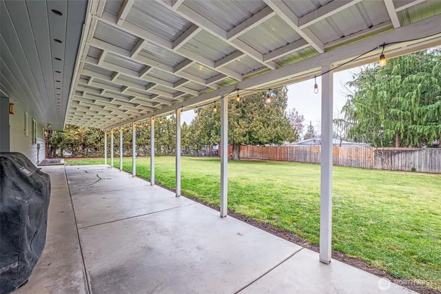 a view of a backyard with porch and garden