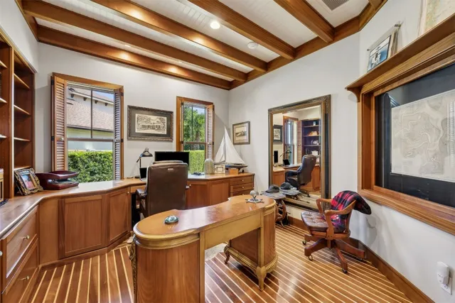 a kitchen with stainless steel appliances granite countertop a sink a refrigerator and a wooden floor