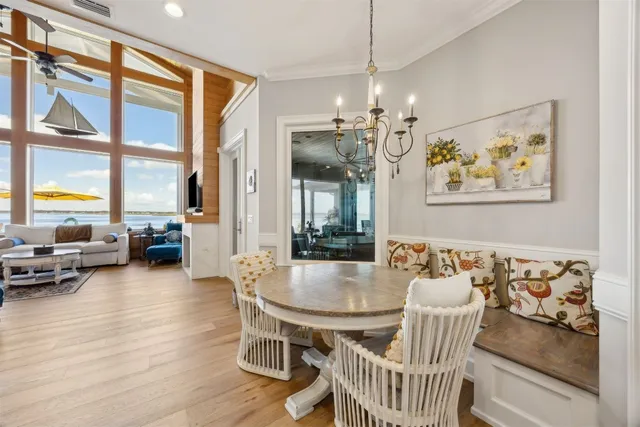 a view of a hallway with wooden floor and windows