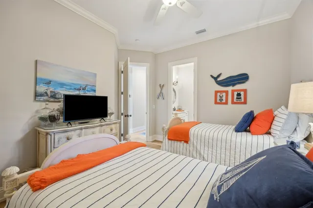 a view of a bedroom with wooden floor and windows