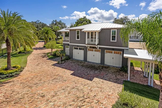 a front view of a house with swimming pool and porch