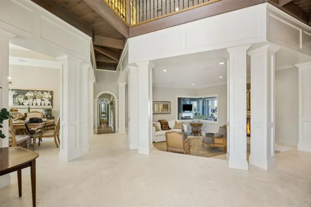 a view of a dining room with furniture a chandelier and wooden floor