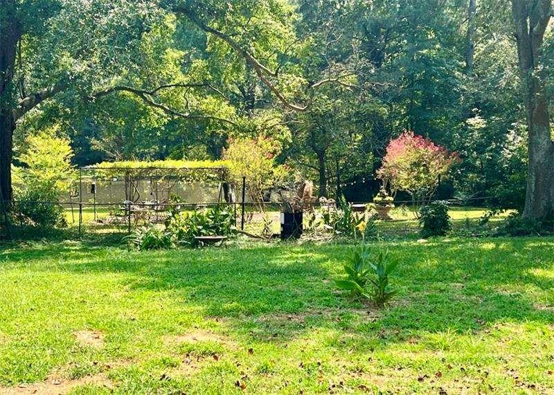 3521 Clay Road Southwest Austell, GA 30106 - Photo 13 of 13 a backyard of a house with lots of green space and fountain