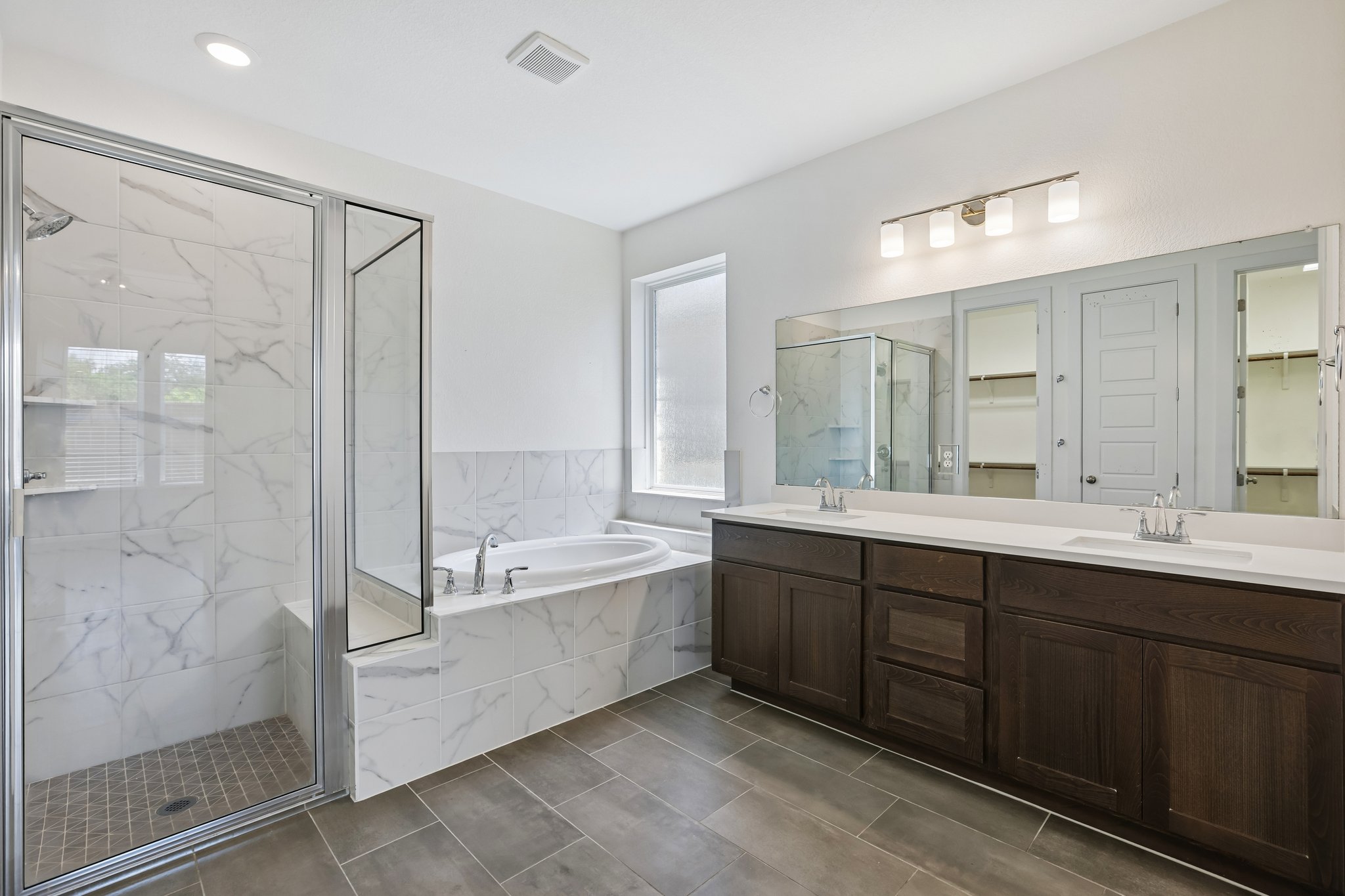 317 Independence Drive Kyle, TX 78640 - Photo 20 of 40 a spacious bathroom with a bathtub shower sink mirror and