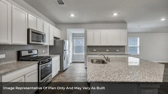a kitchen with kitchen island granite countertop a stove and a sink