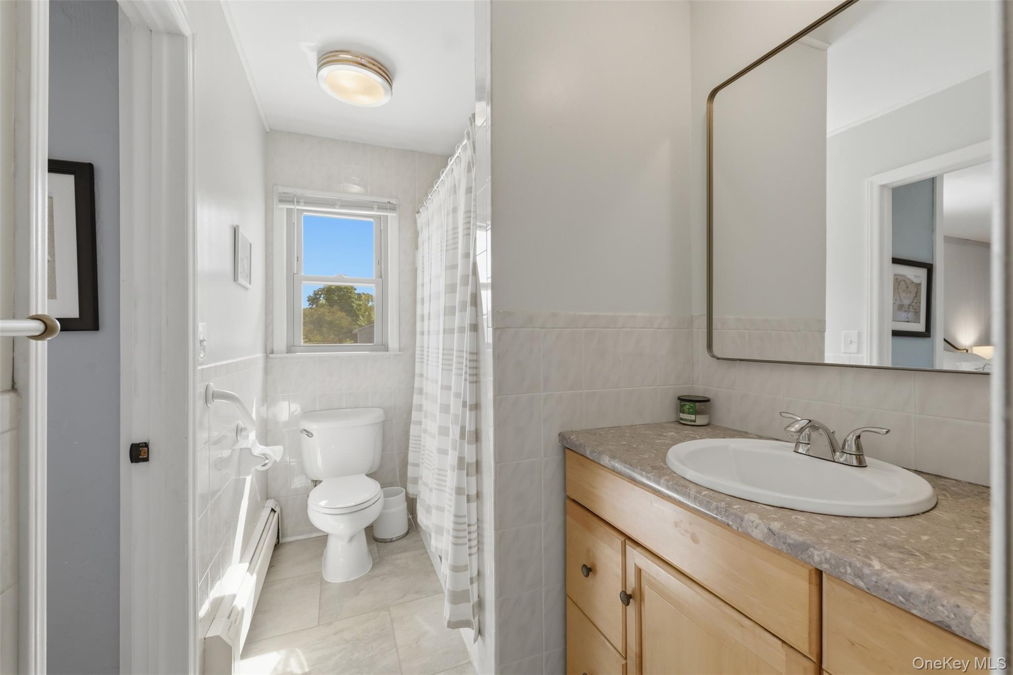 24 Beatty Road Wappingers Falls, NY 12590 - Photo 18 of 36 a bathroom with a granite countertop sink a toilet and a mirror