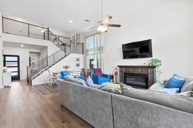a living room with furniture a flat screen tv and a fireplace