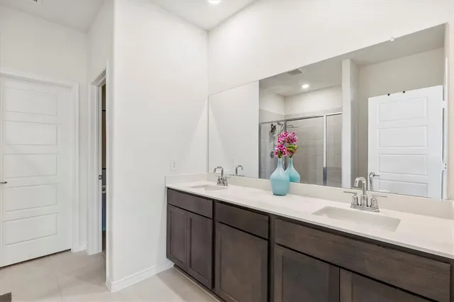 a bathroom with a double vanity sink and a mirror