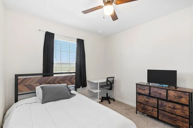 a bedroom with a bed and a television