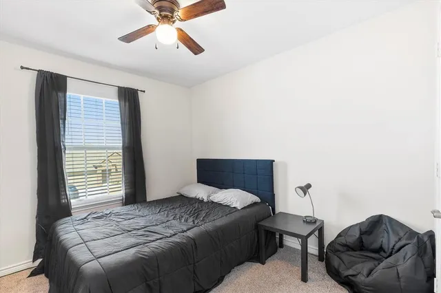 a bedroom with a bed and window