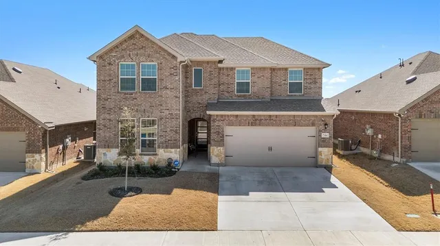 a view of a white house with large windows and a table and chairs