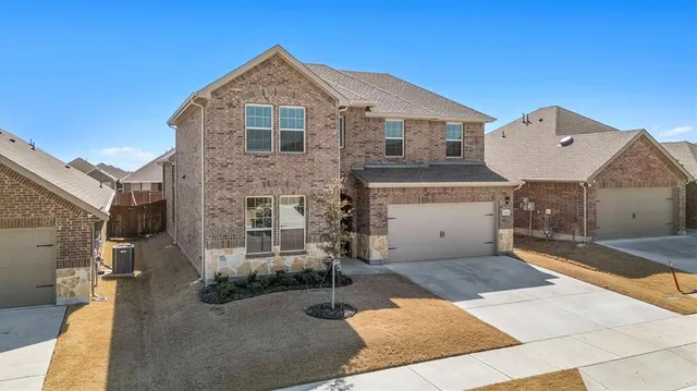 a front view of a house with parking area