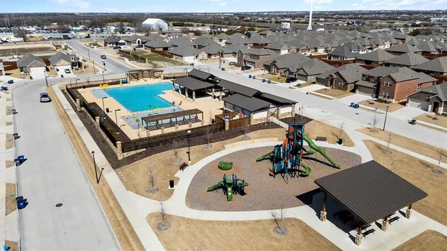 an aerial view of a house with a swimming pool
