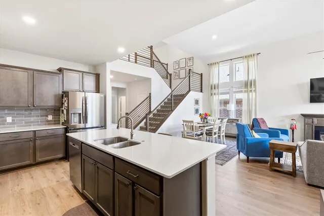 a kitchen with a stove a refrigerator and wooden floor