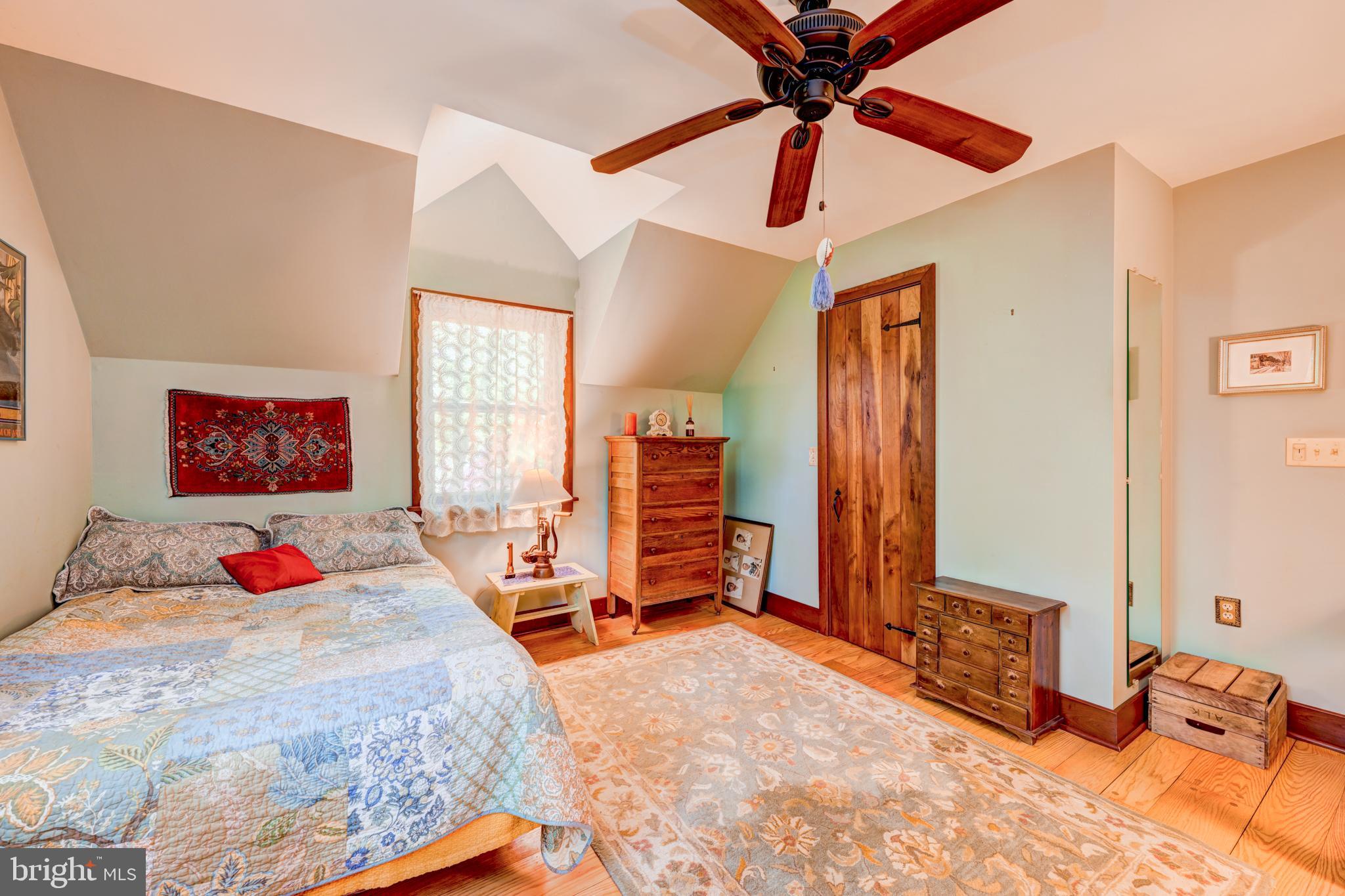 5613 Point Pleasant Pike Doylestown, PA 18902 - Photo 24 of 39 a bedroom with a bed and a chandelier