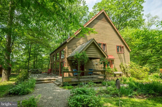 a view of house with backyard