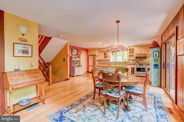 a dining room with furniture entryway and wooden floor