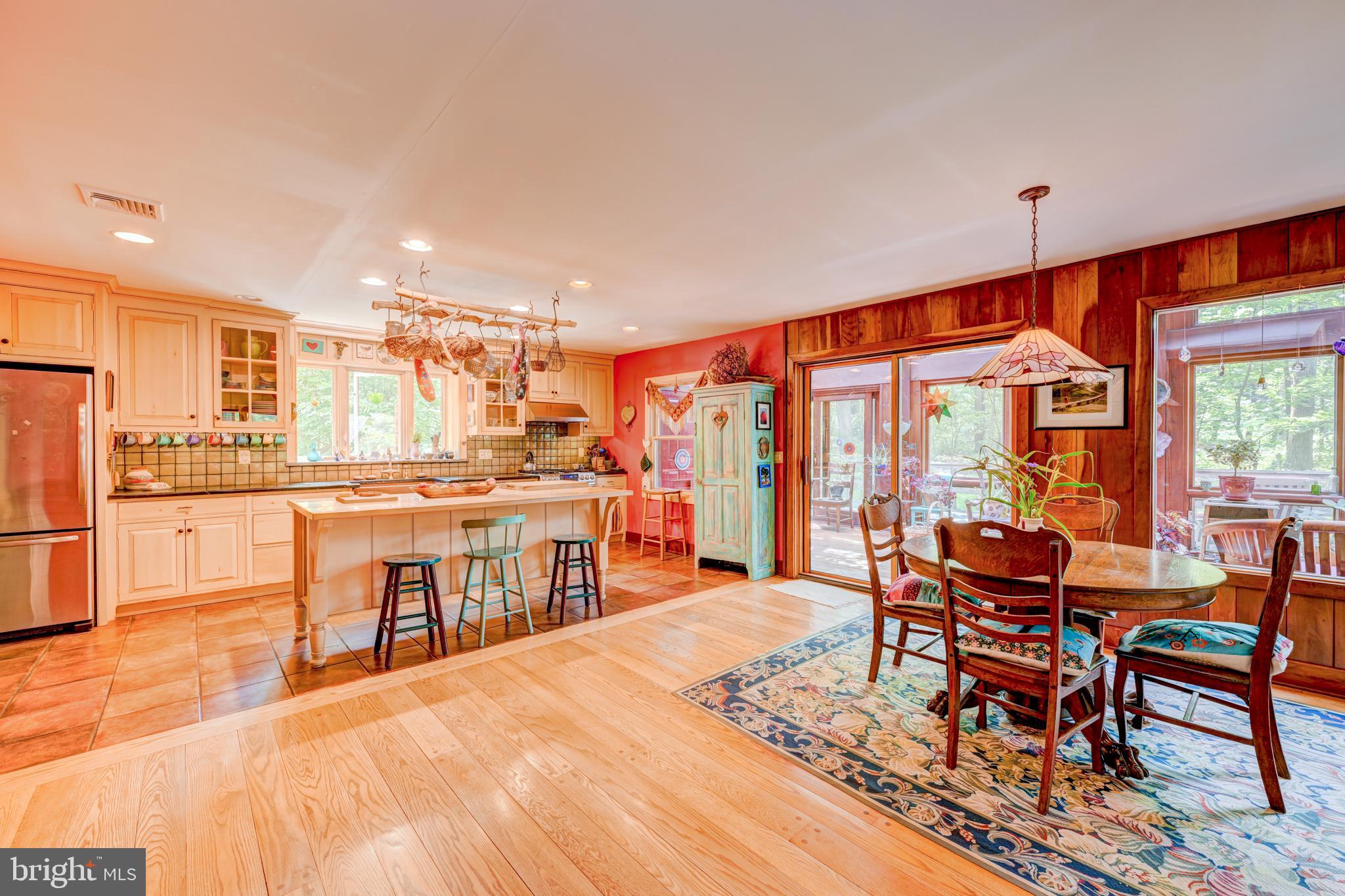 5613 Point Pleasant Pike Doylestown, PA 18902 - Photo 5 of 39 a dining hall with stainless steel appliances kitchen island granite countertop a dining table and chairs with the wooden floor