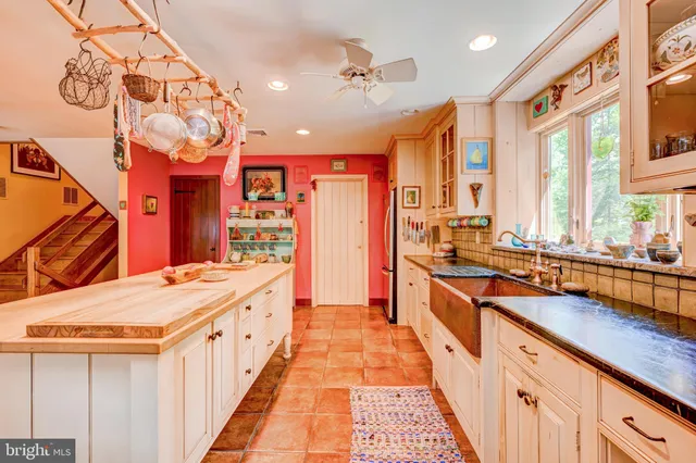 a large kitchen with stainless steel appliances lots of counter space and a sink