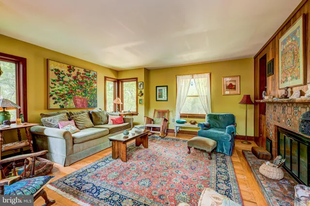 a living room with furniture fireplace and a table