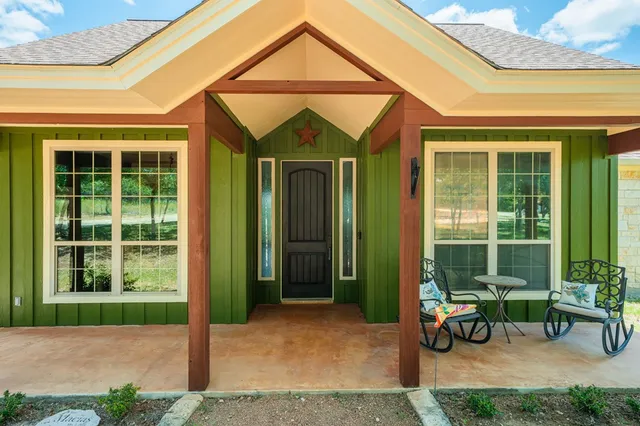 a backyard of a house with outdoor seating