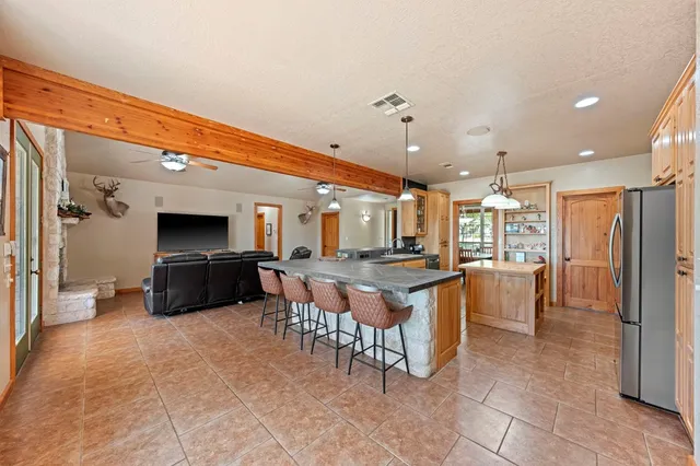 a large kitchen with a table and chairs in it