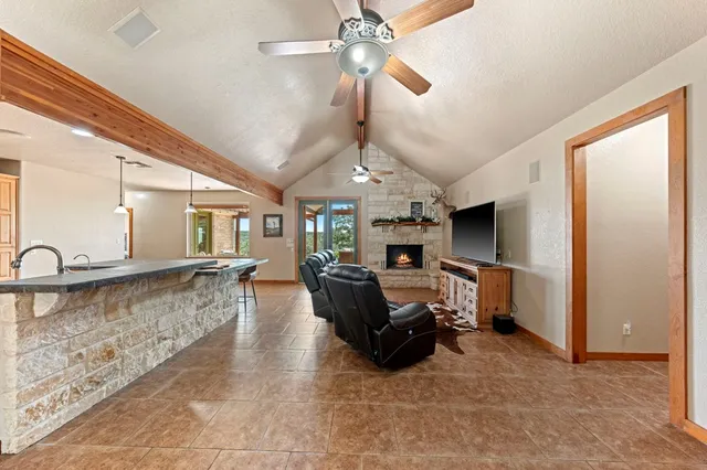 a living room with furniture a dining table and a fireplace