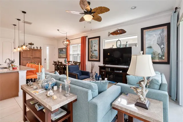 a living room with furniture a flat screen tv and kitchen view