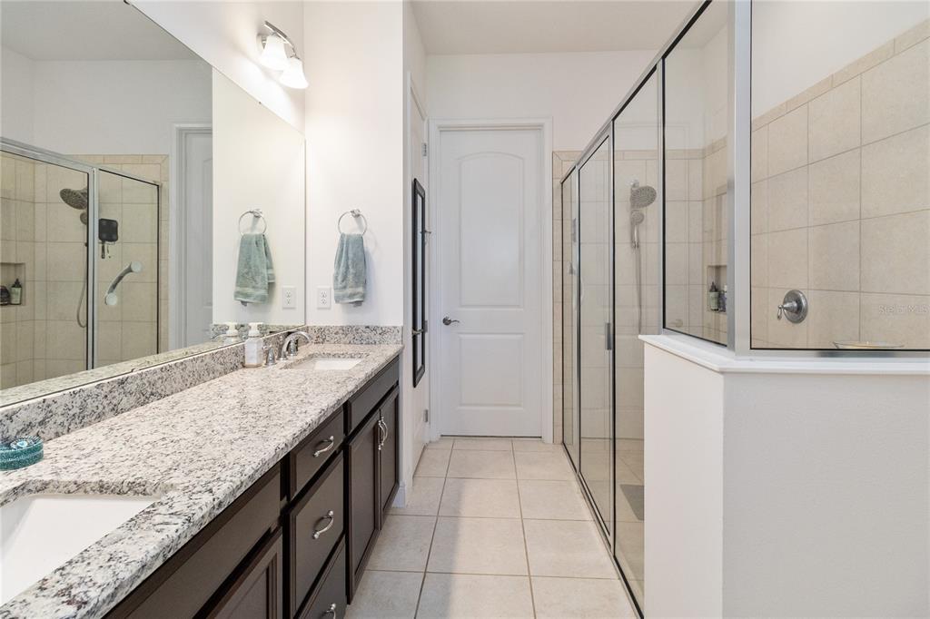 2557 Yellow Brick Road St. Cloud, FL 34772 - Photo 20 of 41 a bathroom with a granite countertop sink and a mirror