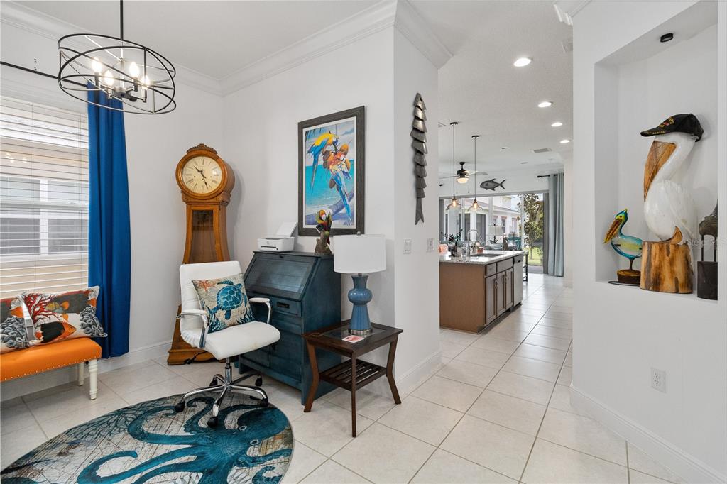 2557 Yellow Brick Road St. Cloud, FL 34772 - Photo 24 of 41 a living room with furniture a chandelier and a dining table