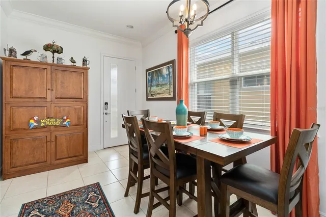 a view of a dining room with furniture and chandelier