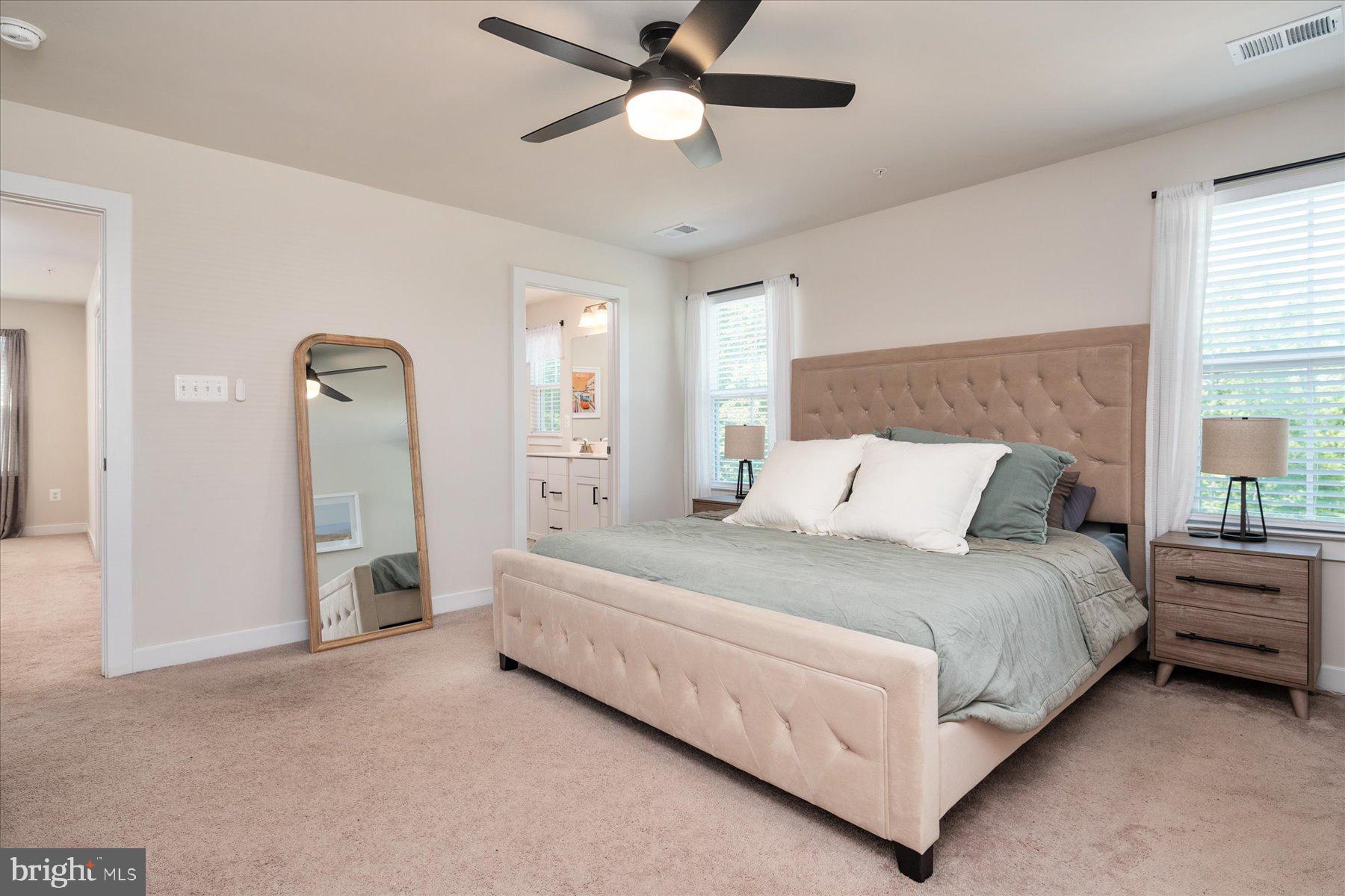 1261 Upper Patuxent Ridge Road Odenton, MD 21113 - Photo 17 of 58 a spacious bedroom with a bed and a chandelier