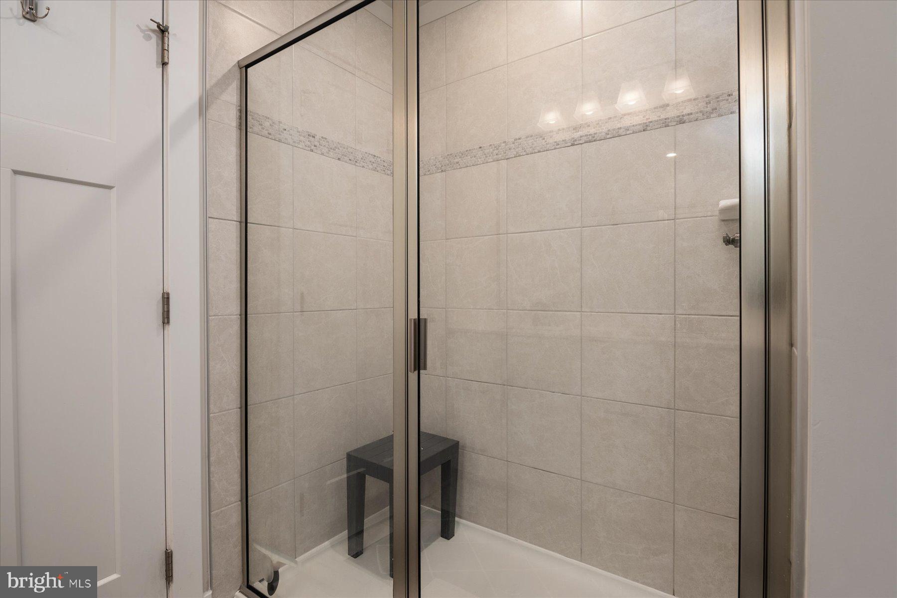 1261 Upper Patuxent Ridge Road Odenton, MD 21113 - Photo 19 of 58 a bathroom with a glass shower door