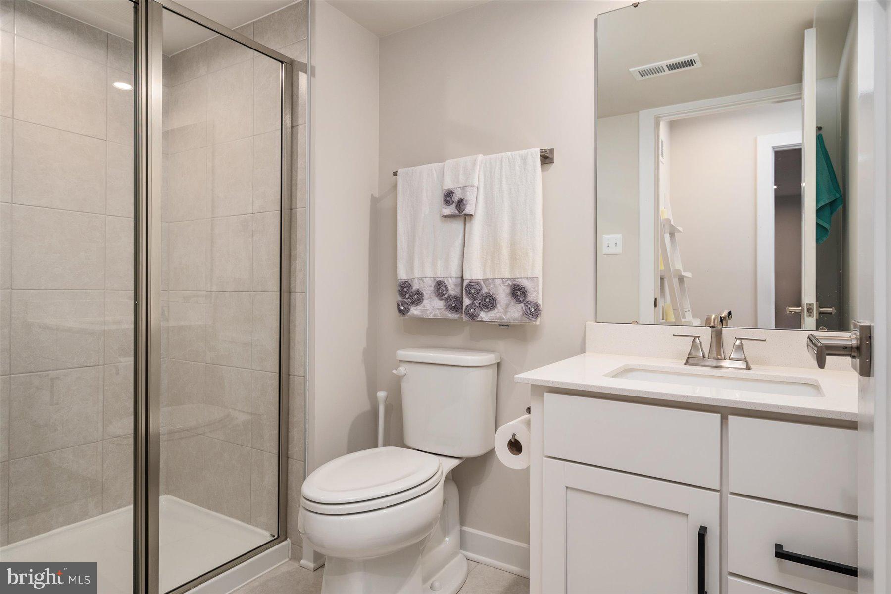 1261 Upper Patuxent Ridge Road Odenton, MD 21113 - Photo 33 of 58 a bathroom with a sink toilet and shower