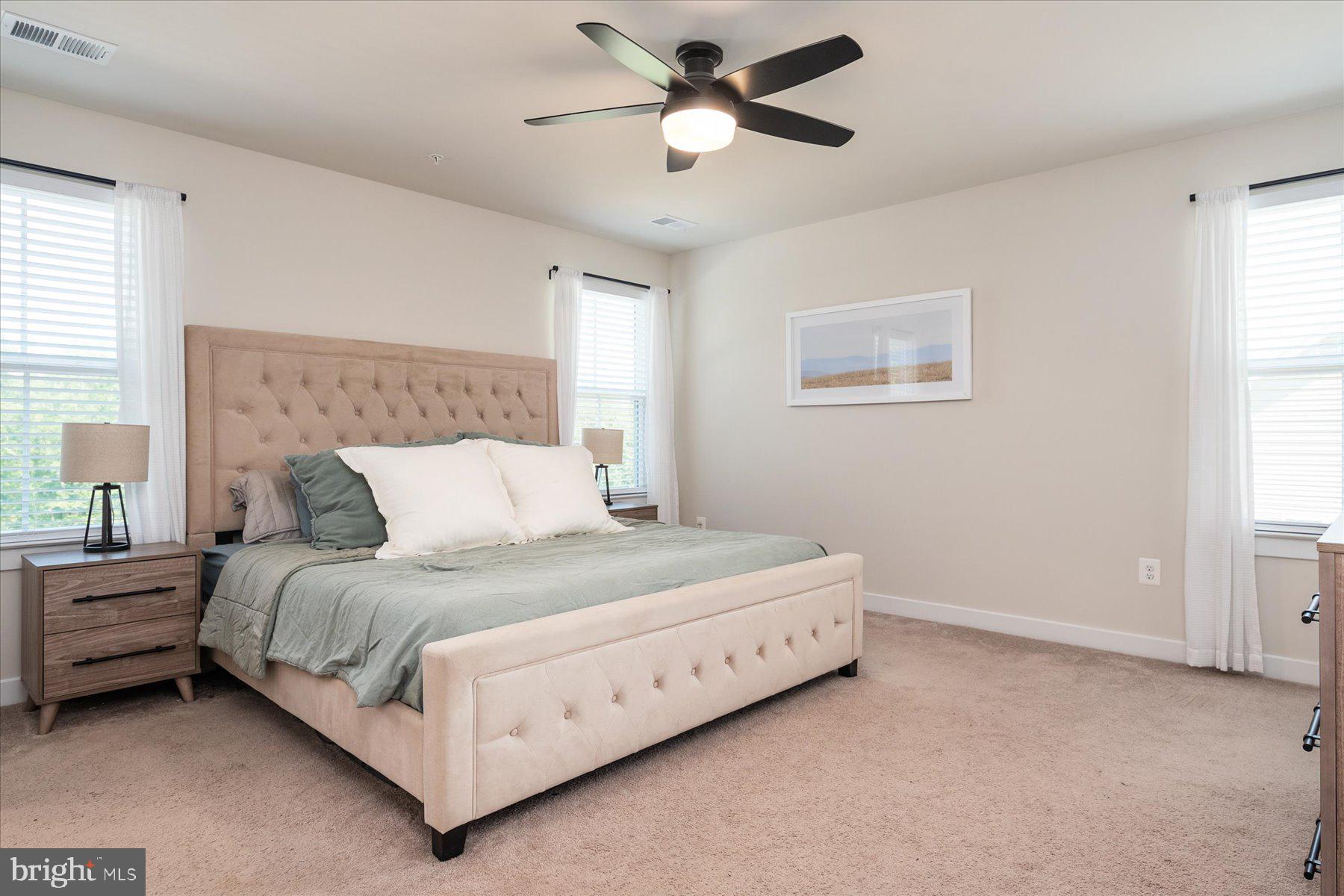 1261 Upper Patuxent Ridge Road Odenton, MD 21113 - Photo 4 of 58 a bedroom with a bed and a ceiling fan