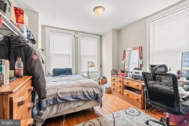 a bedroom with a bed and a flat tv screen